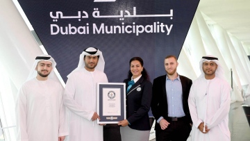 Photo: Dubai Municipality achieves Guinness World Record for building world's longest Braille handrail in Dubai Frame